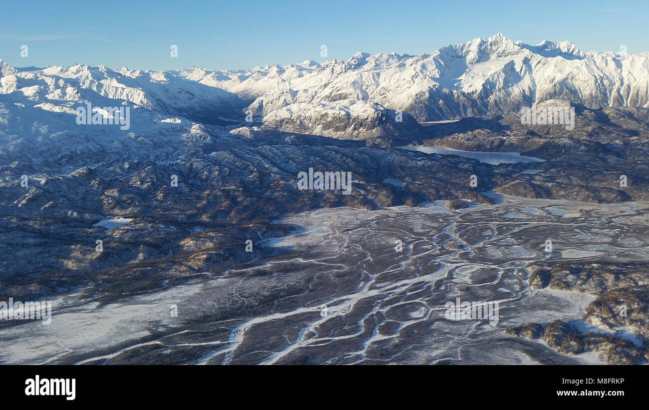 Aerial View   .An aerial view of one of Lake Clark's many braided rivers beneath snow covered mountains during the month of January Stock Photo