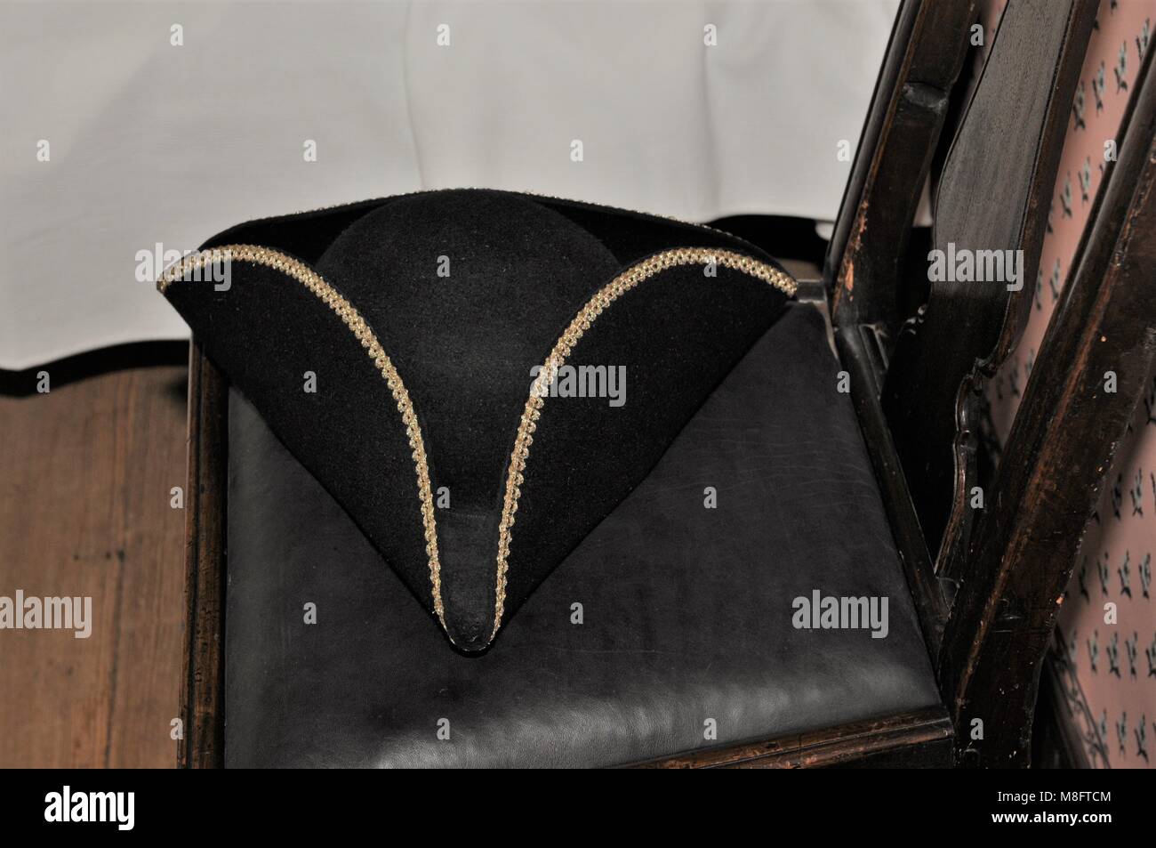 Tricorn hat sitting on a chair in a colonial home Stock Photo
