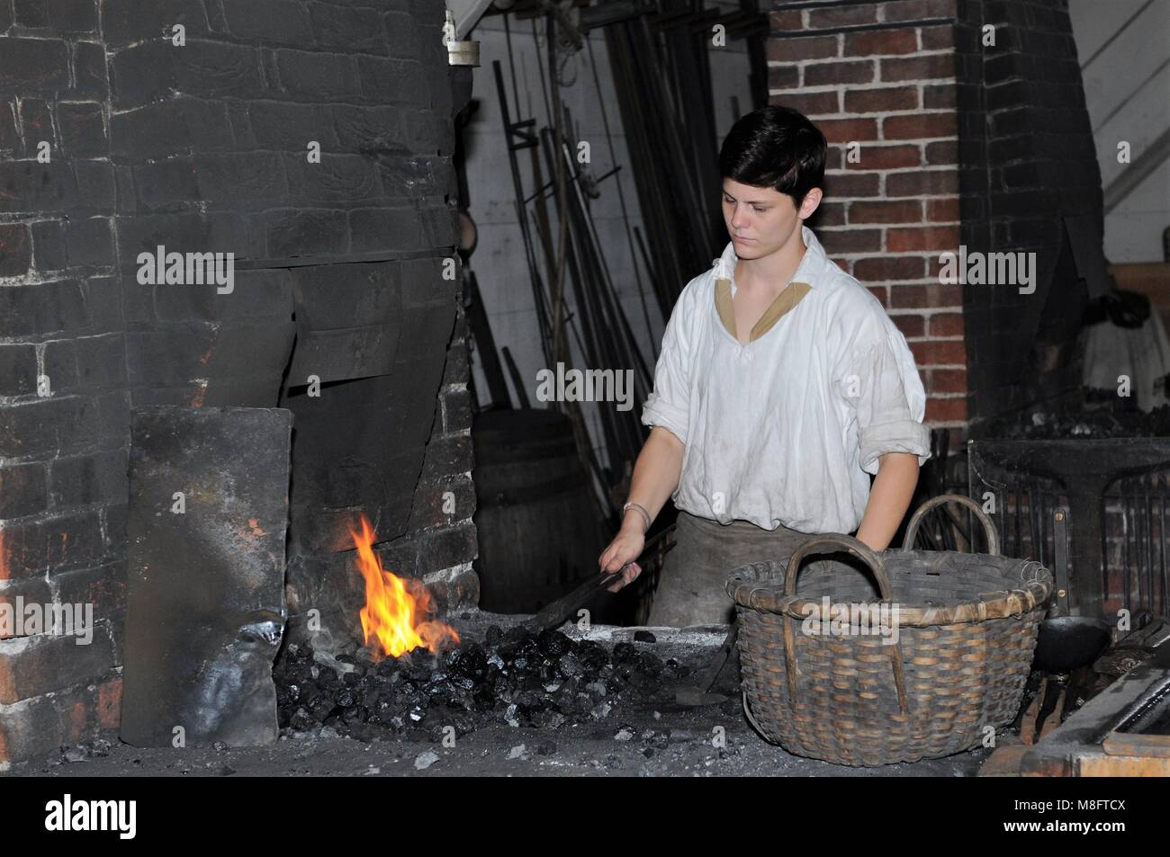 A blacksmith apprentice at work at the in Colonial Williamsburg