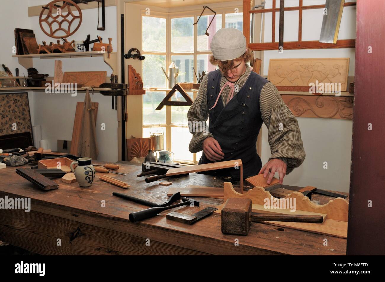 Joiner's apprentice at work assembling a drawer in the joiner shop in Colonial Williamsburg, Virginia Stock Photo