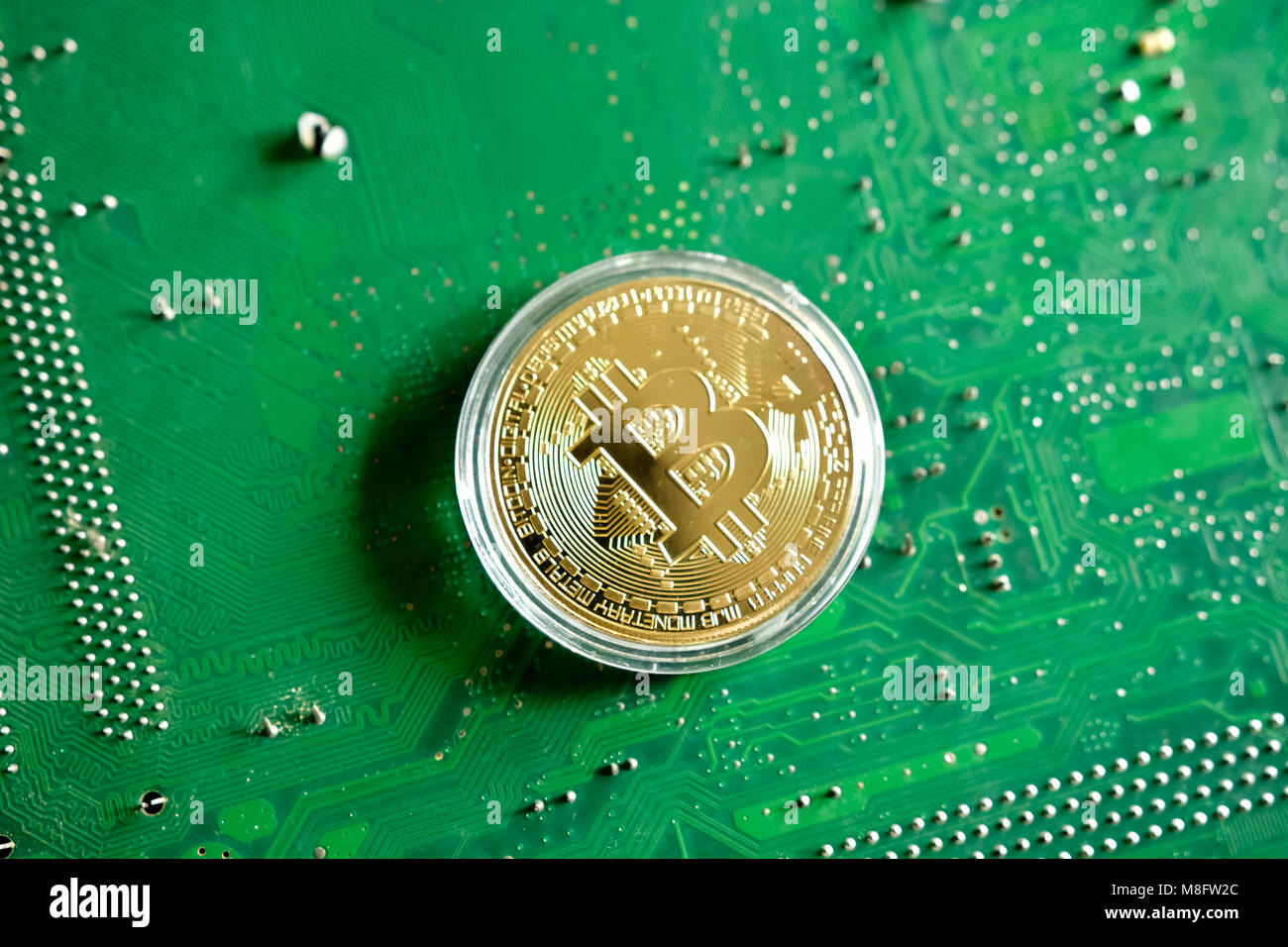 Bitcoin on computer motherboard circuit background Stock Photo - Alamy