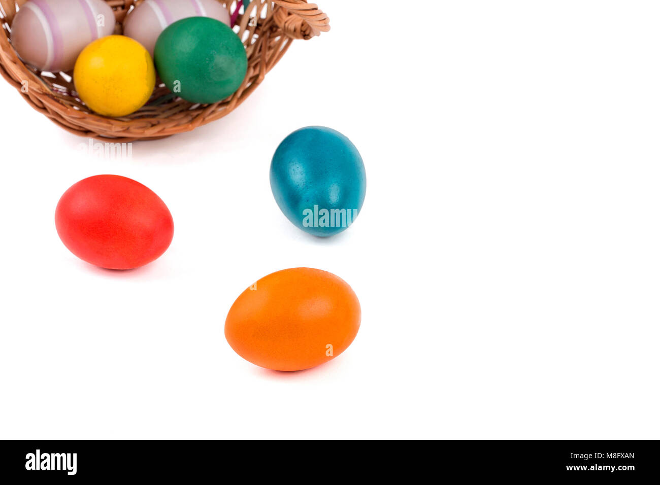 Easter eggs in a basket on a white background Stock Photo