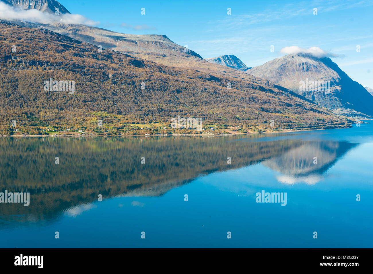 Calm placid freshwater lake surrounded by barren mountains Stock Photo