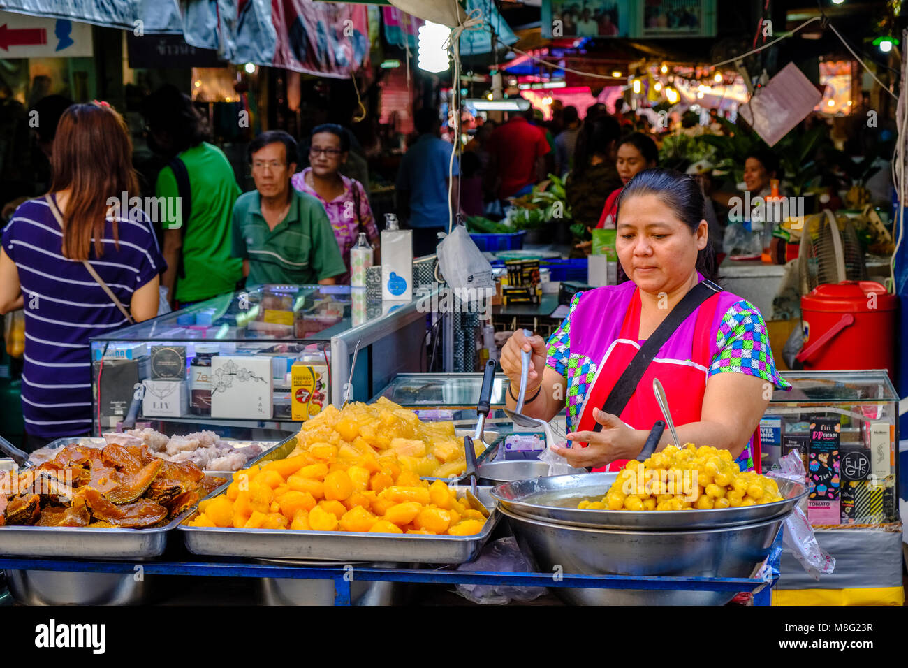 A woman is selling snacks at Nonthaburi Market Stock Photo