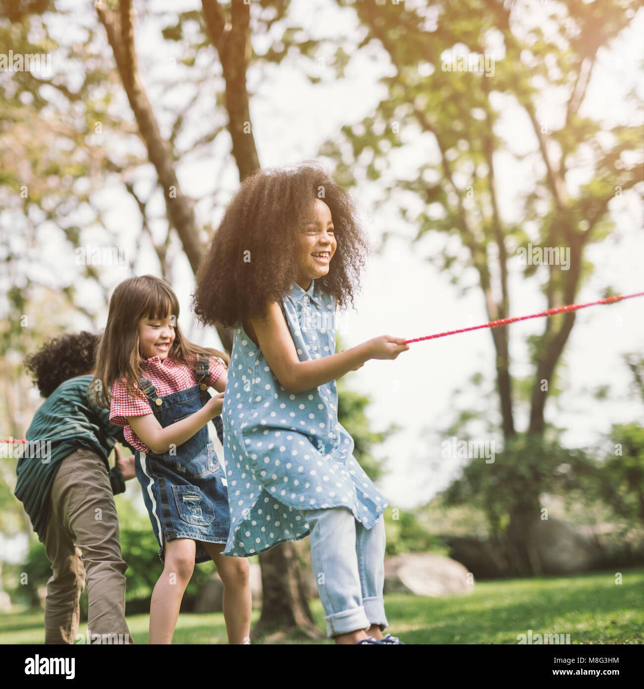 Two happy little asian kids playing outdoor in the sunny park Stock Photo -  Alamy