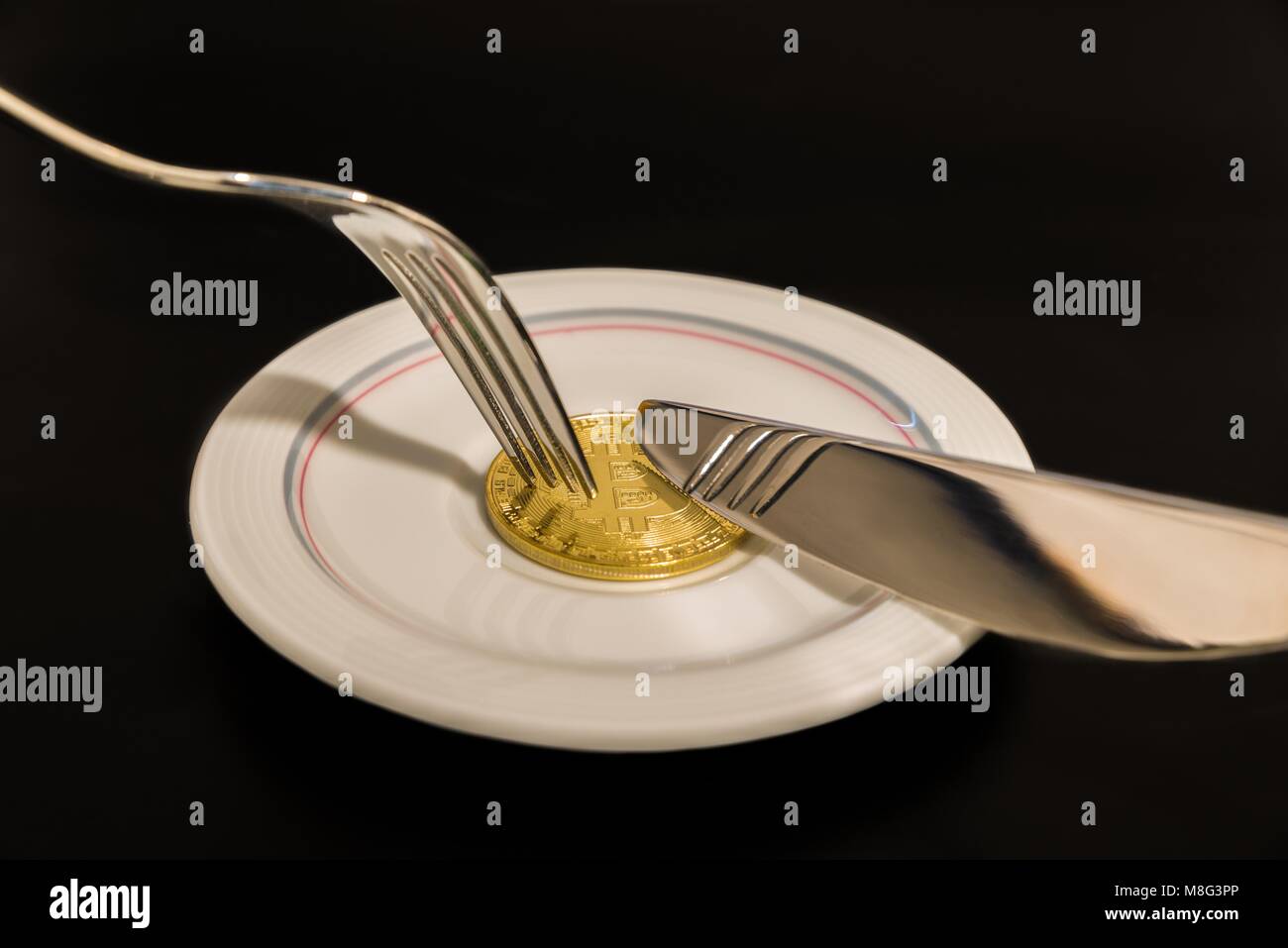 Gold coin bitcoin on plate with knife and fork isolated on black background  Stock Photo - Alamy