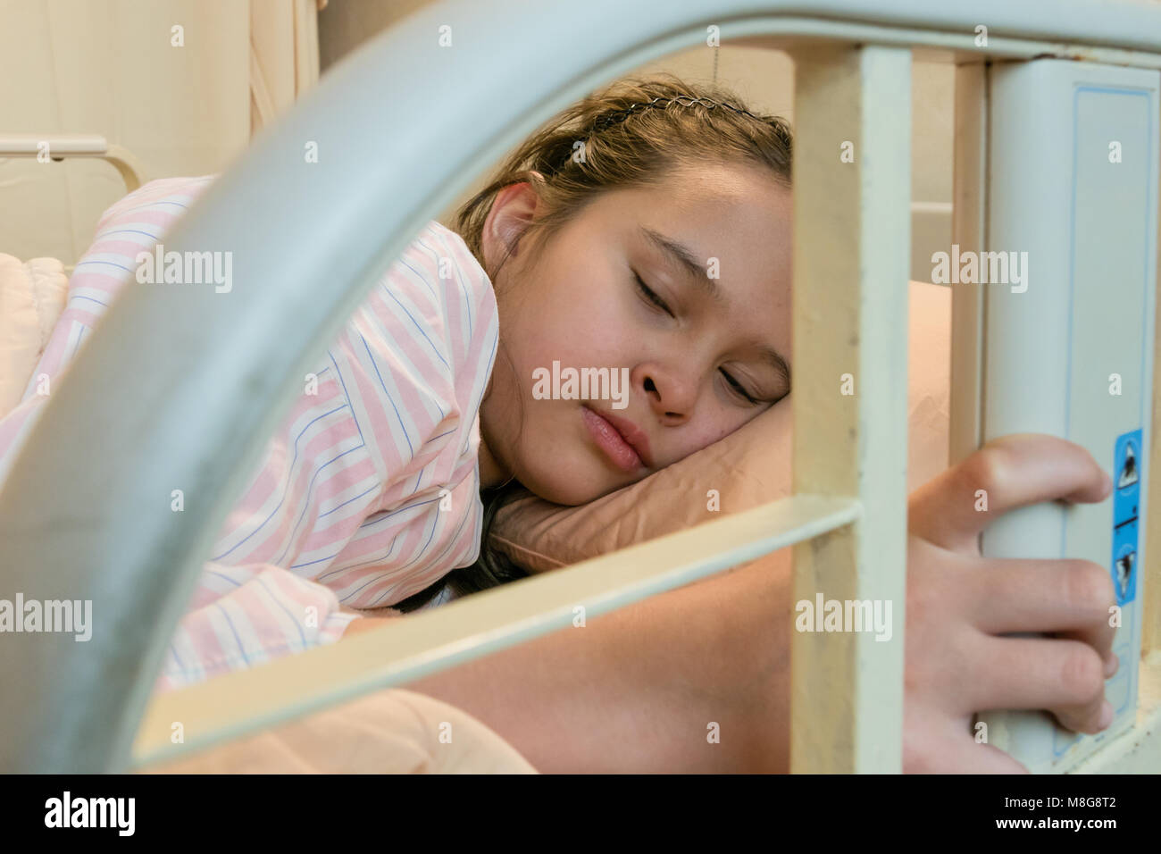 Mixed race Asian American tween girl in hospital bed Stock Photo Alamy