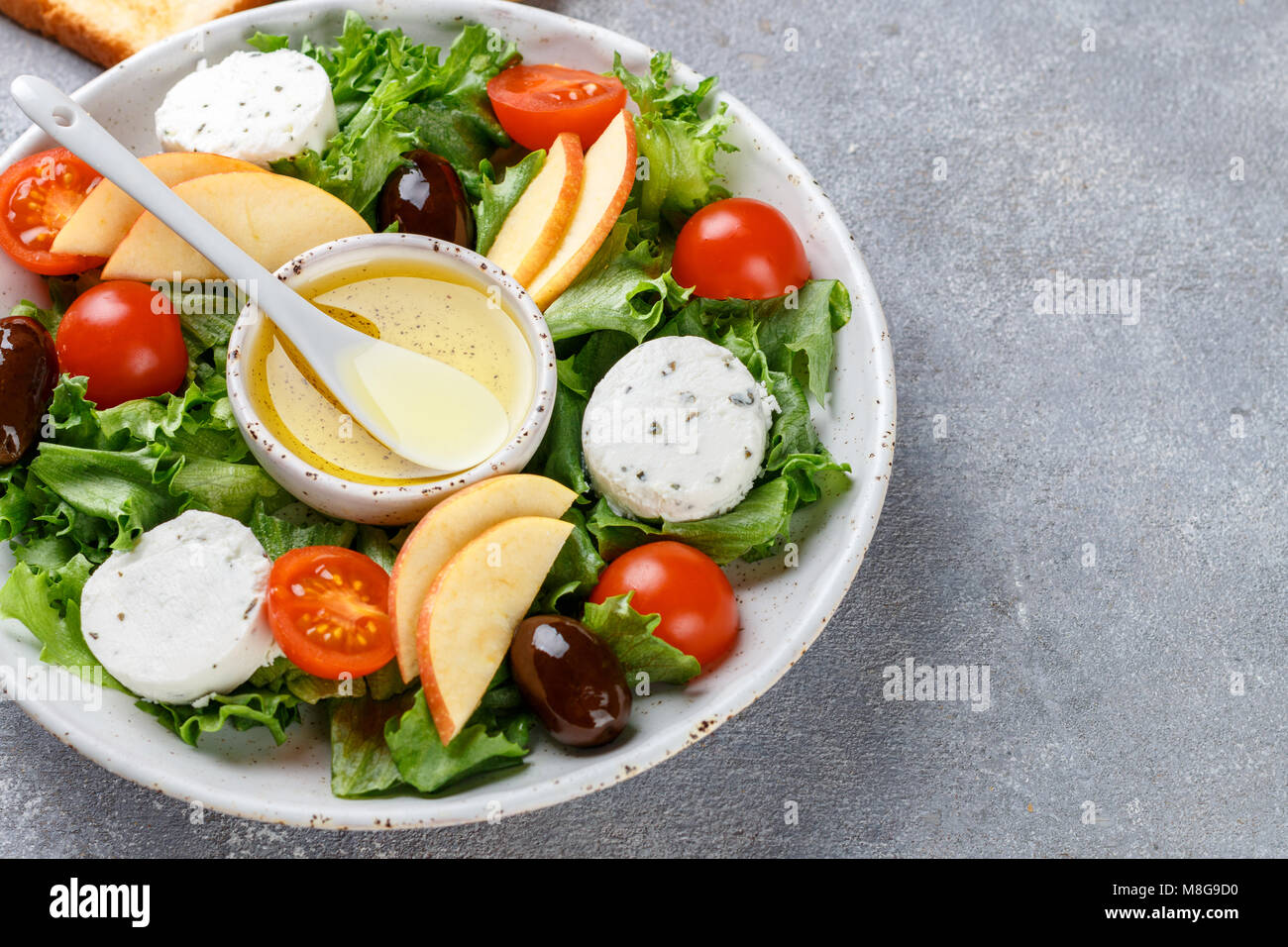 Fresh, delicious goat's cheese salad with lettuce, cherry tomatoes