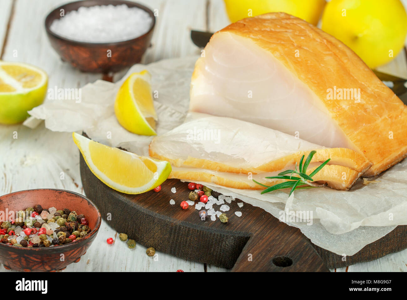 Salted white fish with lemon, rosemary and spices salt and pepper