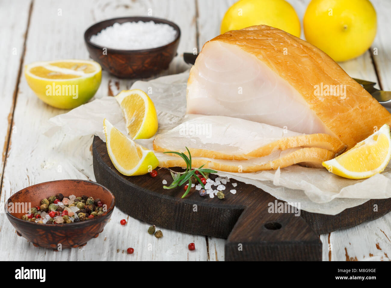 Salted white fish with lemon, rosemary and spices salt and pepper