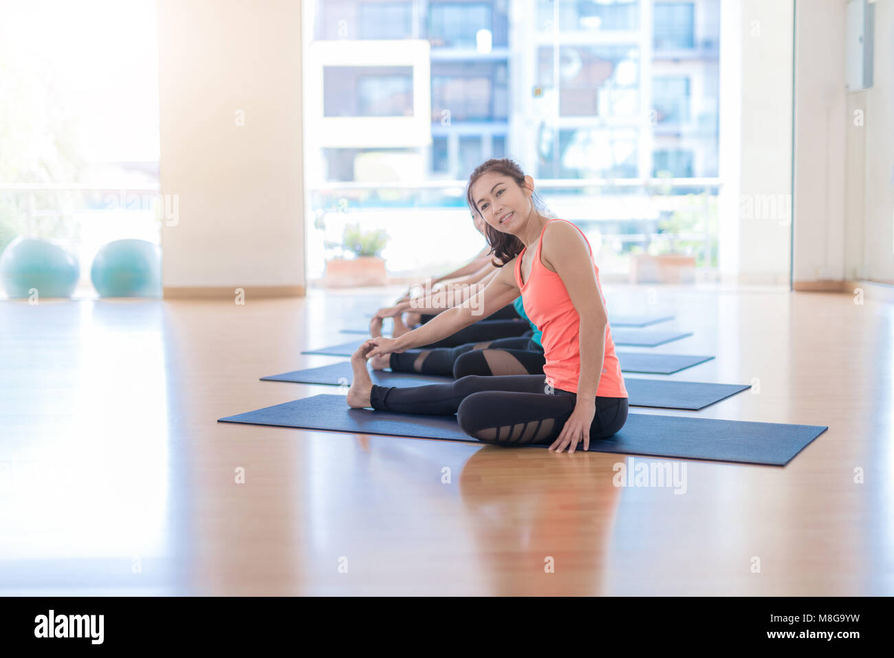 Fitness Asian woman at stretching training at gym fitness center. Young slim  girl makes aerobics exercise.Yoga Practice Exercise Class Concept Stock  Photo - Alamy