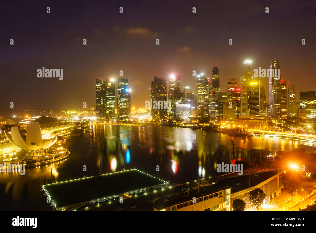 The towers of the Central Business District and Marina Bay by night, Singapore Stock Photo