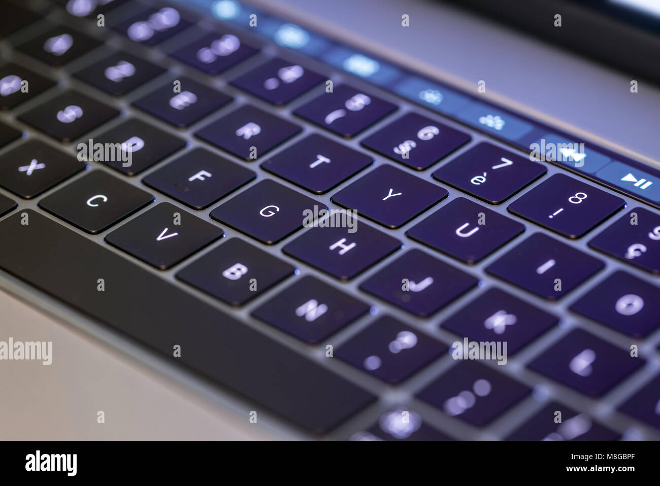 Bright keyboard and touch screen bar on metallic gray laptop Stock Photo