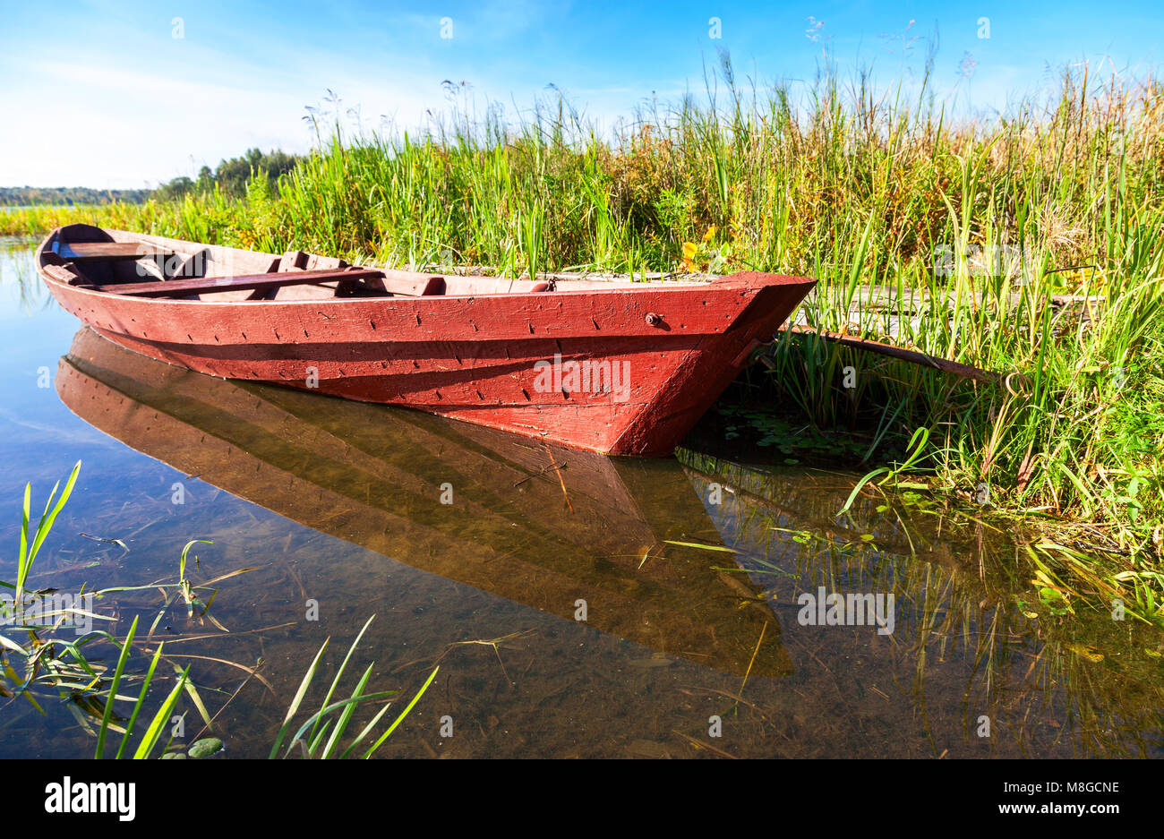 Old fishing wooden boat at the lake in sunny summer day Stock Photo - Alamy