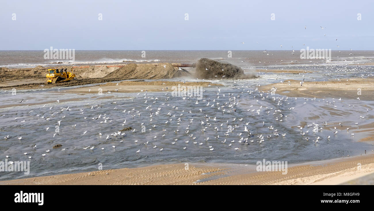 Pumping sand onto the beach to replace what has been lost due to rising sea levels. Stock Photo