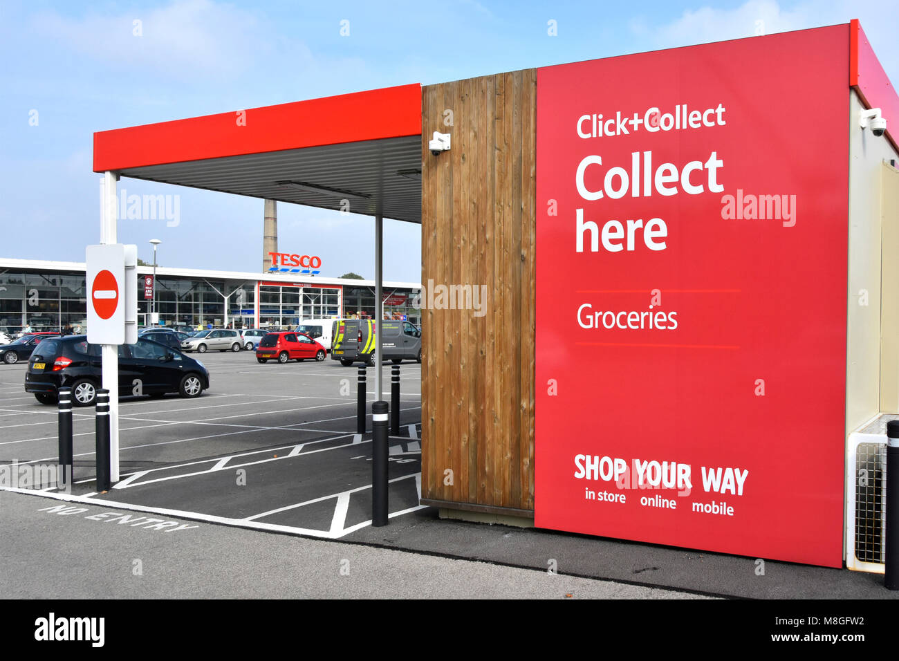 Red Tesco superstore supermarket click and collect under cover groceries facility in car park online internet grocery shopping Cambridge England UK Stock Photo
