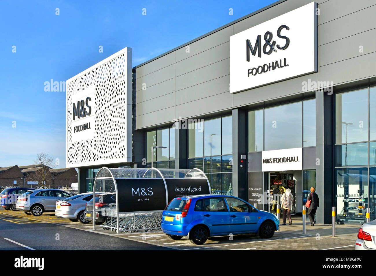 Free car park outside M&S modern shop front building at Marks and Spencer foodhall in retail park food shopping customer enters Chelmsford Essex UK Stock Photo