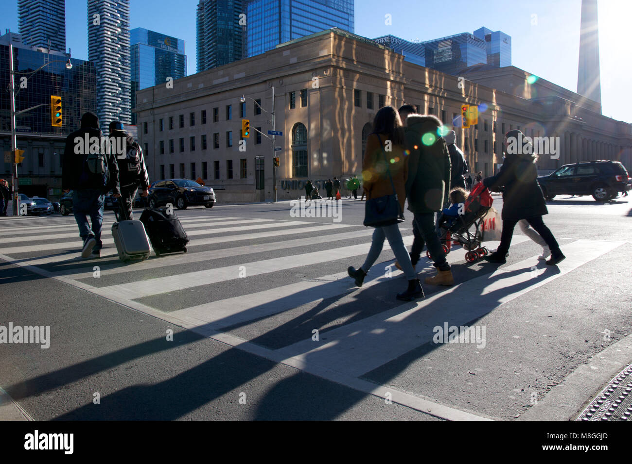Toronto, Ontario/ Canada - 03-04-2018: pedestrian crossing the road at the downtown district Stock Photo