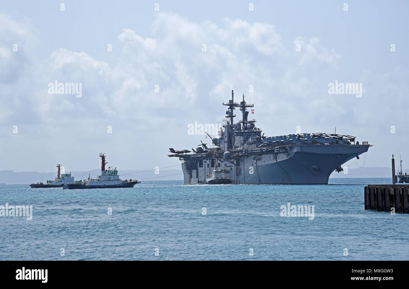 180315-N-YG104-0001 OKINAWA, Japan (March 15, 2018) The amphibious assault ship USS Wasp (LHD 1) arrives at White Beach Naval Facility to embark the 31st Marine Expeditionary Unit (MEU). Wasp, part of the Wasp Expeditionary Strike Group, is conducting a regional patrol designed to strengthen regional alliances, provide rapid-response capability and advance the up-gunned ESG concept. (U.S. Navy photo by Mass Communication Specialist 2nd Class Sarah Villegas/ Released) Stock Photo