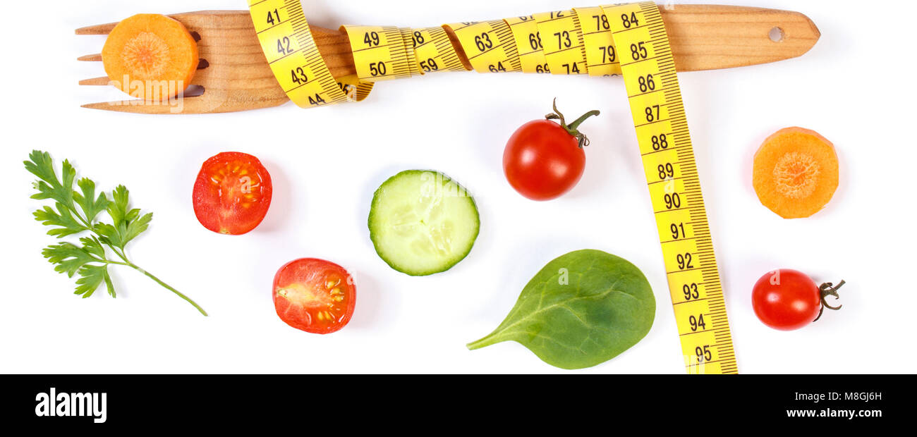 Wooden fork wrapped tape measure and fresh ripe vegetables on white background, concept of slimming and healthy nutrition Stock Photo