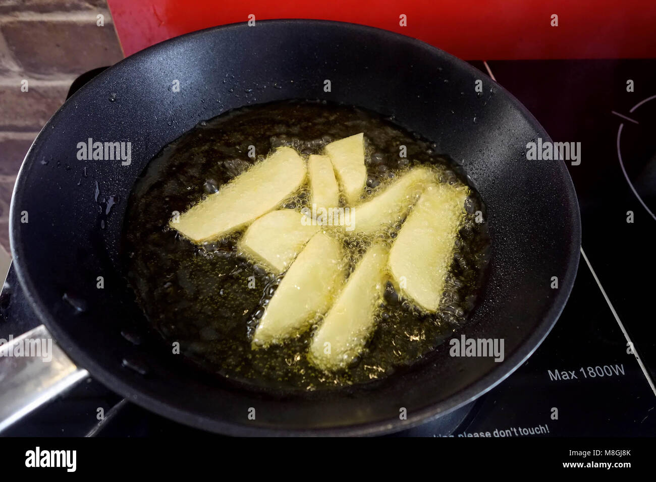 Induction Hob Cooking Chips in a Frying Pan Stock Photo Alamy