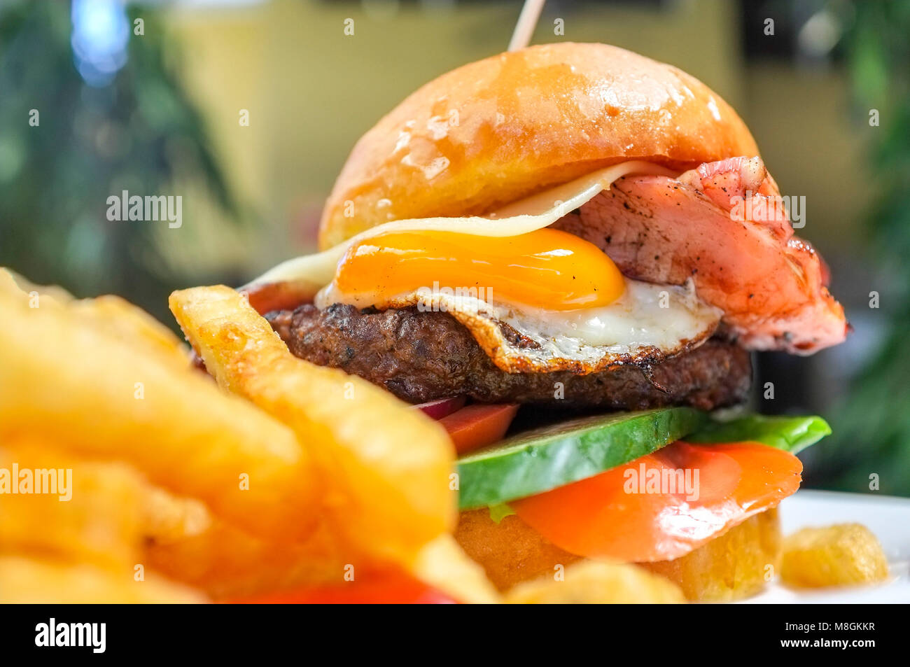 Aussie burger with a side of French fries. Stock Photo