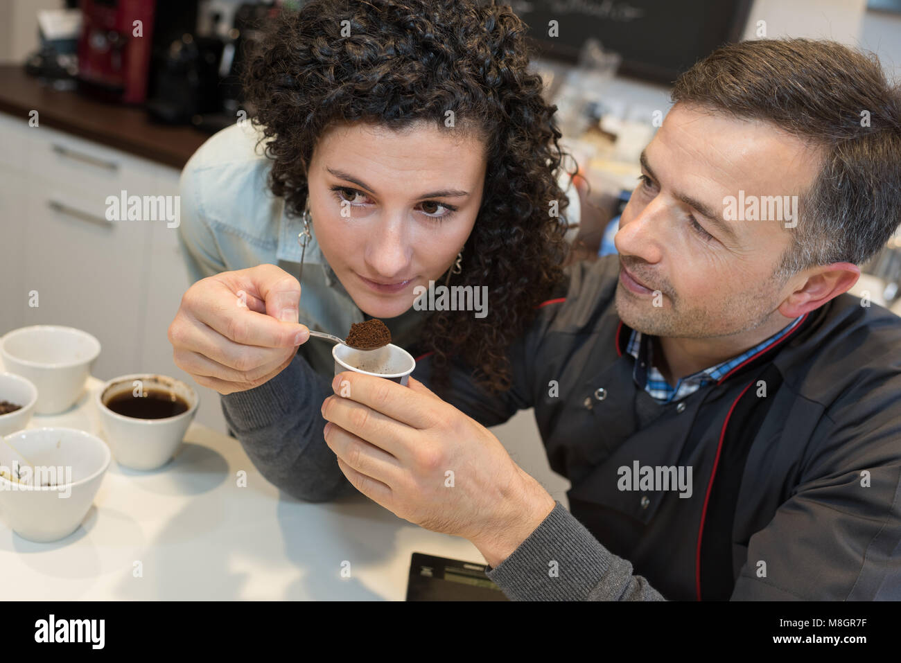 woman smelling sample of ground coffee Stock Photo Alamy