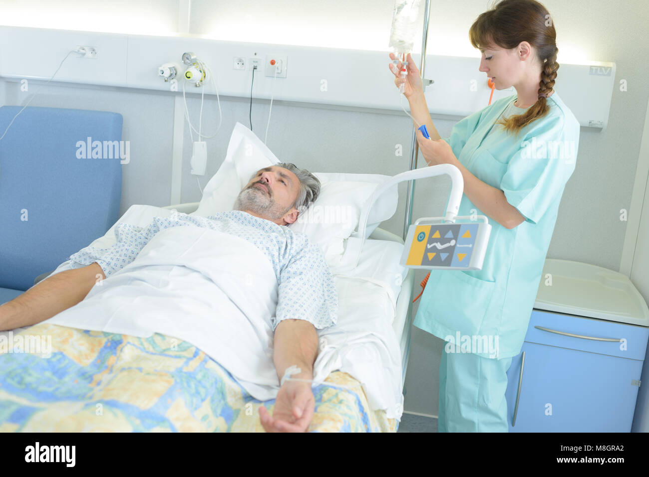 female nurse with patient in bed Stock Photo - Alamy