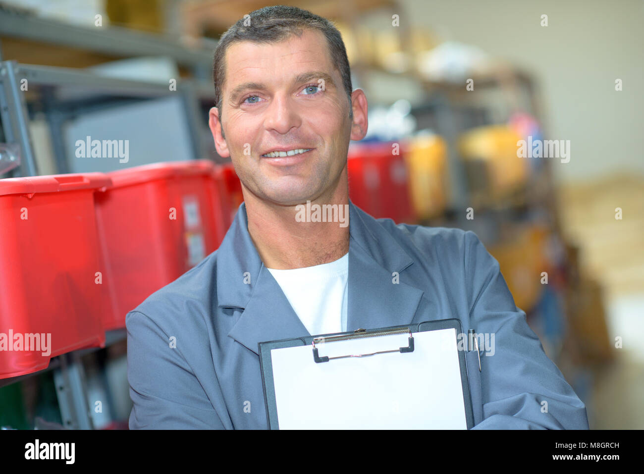 Portrait of man holding blank clipboard Stock Photo - Alamy