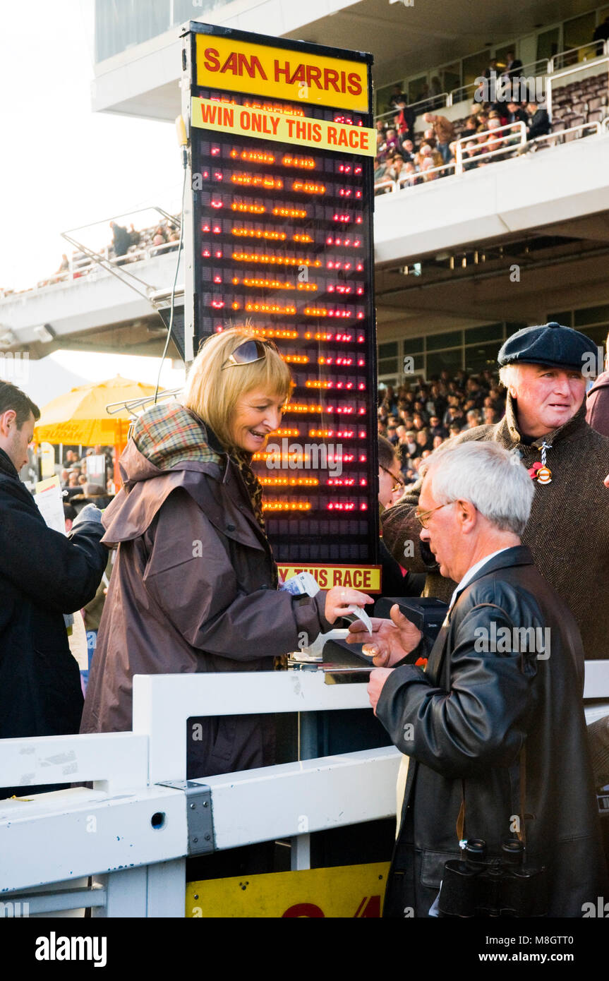A man places a bet at an on-track bookmakers at Cheltenham Racecourse Stock Photo