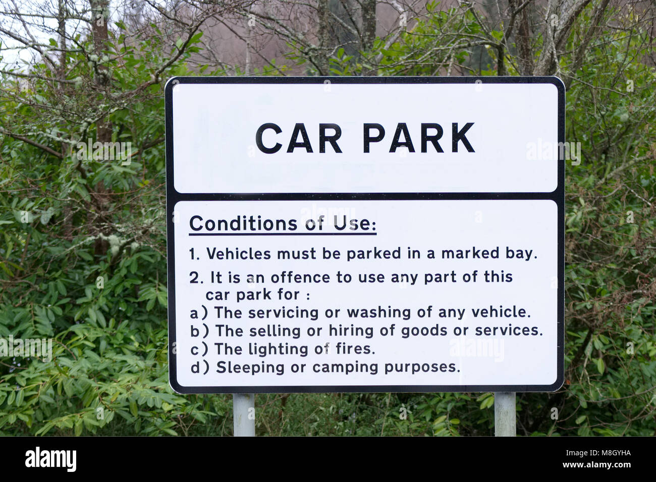 Car park condition of use rules sign post Stock Photo Alamy