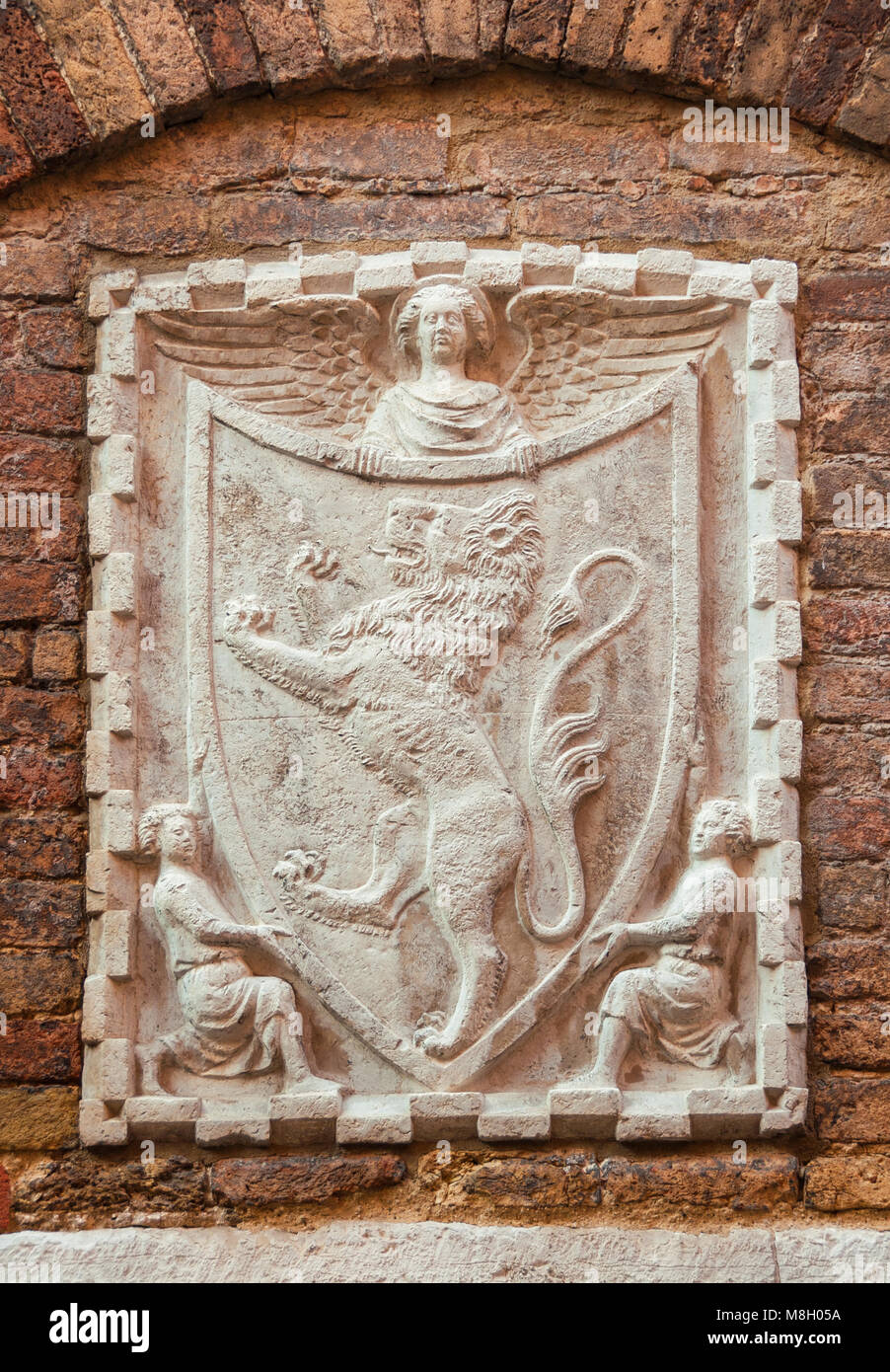 Old heraldic emblem with lion and angel on a Venice wall Stock Photo