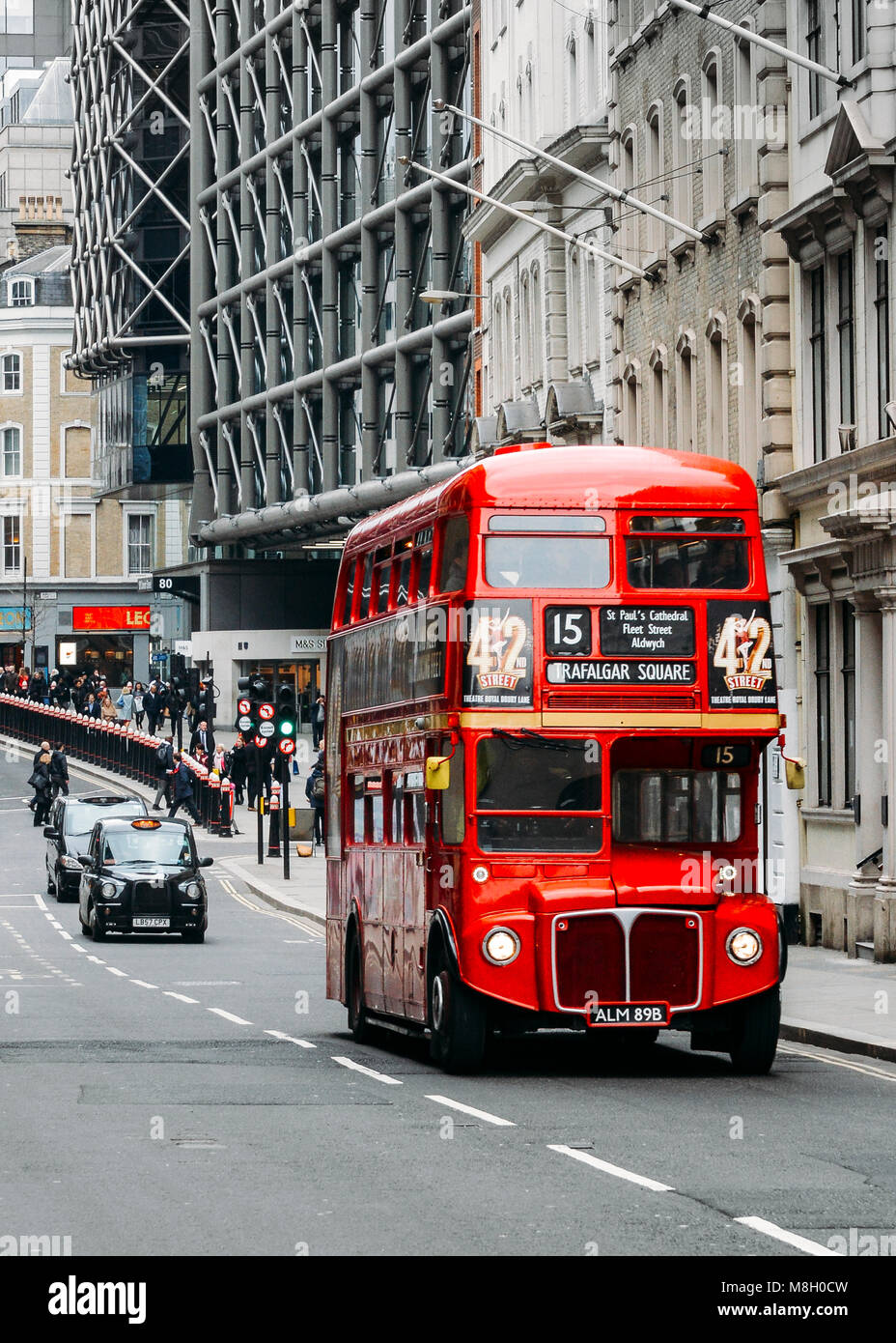 Heritage red Routemaster Bus operating in the City of London. Open platform at back facilitated speedy boarding Stock Photo