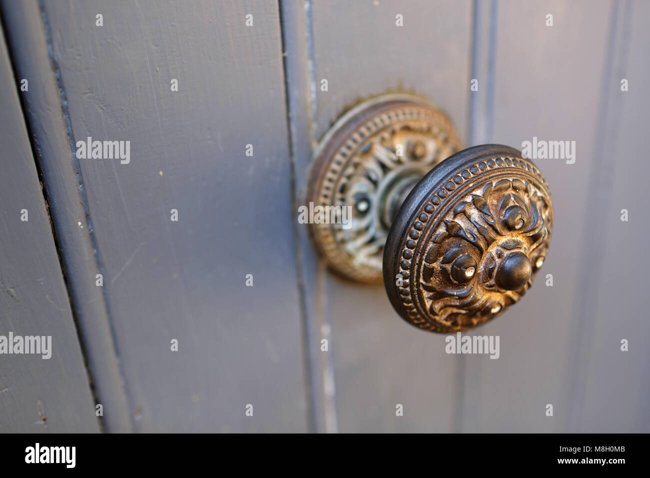 Rusted doorknob, old door handle on rustic wooden door in village of Roussillon, Provence, France Stock Photo