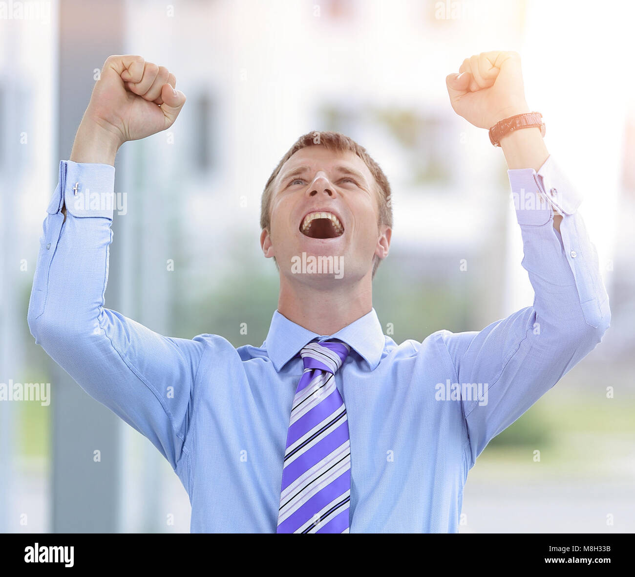 Businessman celebrating with his fists raised in the air Stock Photo ...