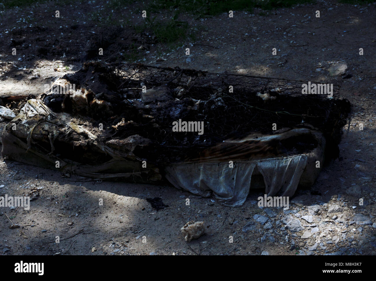 a burned mattress lies on the pavement after a fire Stock Photo Alamy