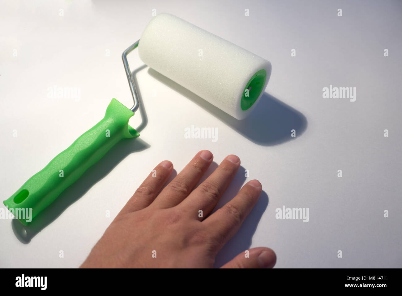 Hand Clean Roller hand with a clean Roller on white background Stock Photo - Alamy