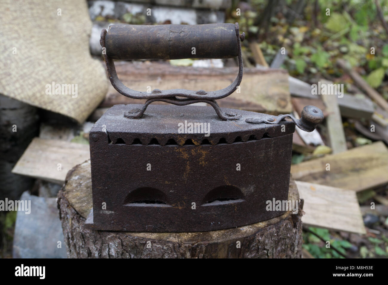three old irons made of castiron on a shirt Stock Photo Alamy