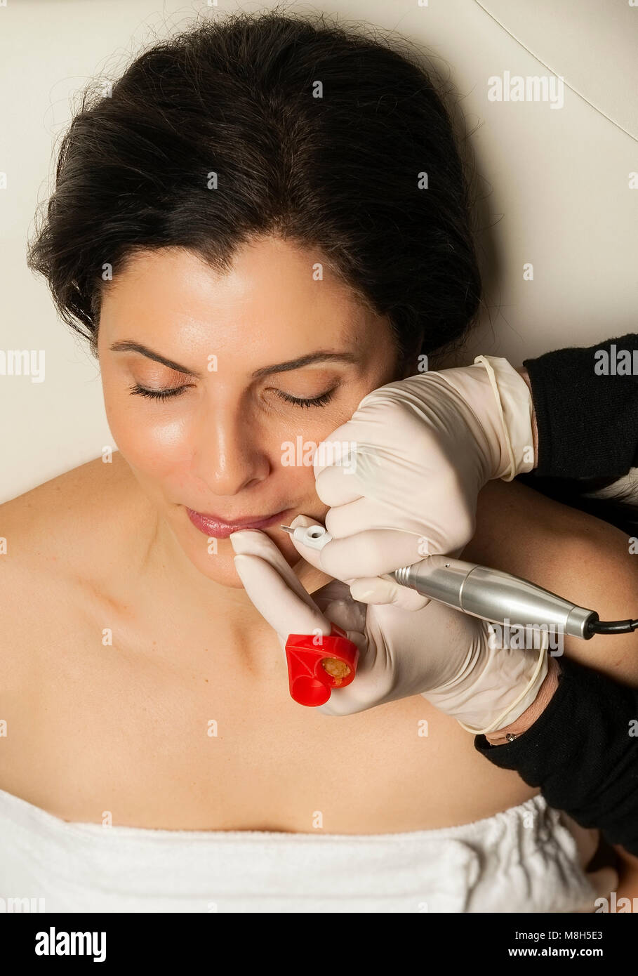 Micropigmentation procedure for the lips, permanent make-up. Stock Photo