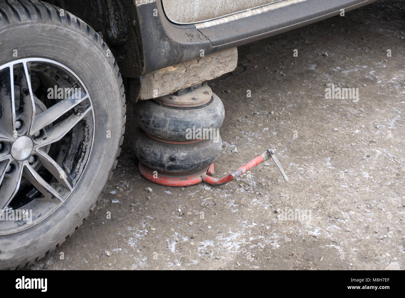 automotive hydraulic Jack under the car to change the wheel Stock Photo