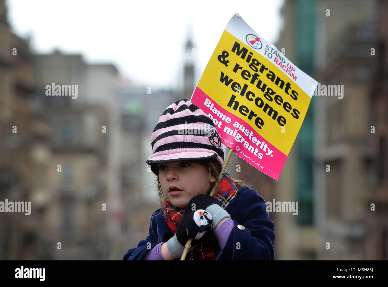 A girl holds a banner welcoming migrants and refugees during an anti-racism rally in Glasgow organised by Stand up to Racism Scotland. Stock Photo