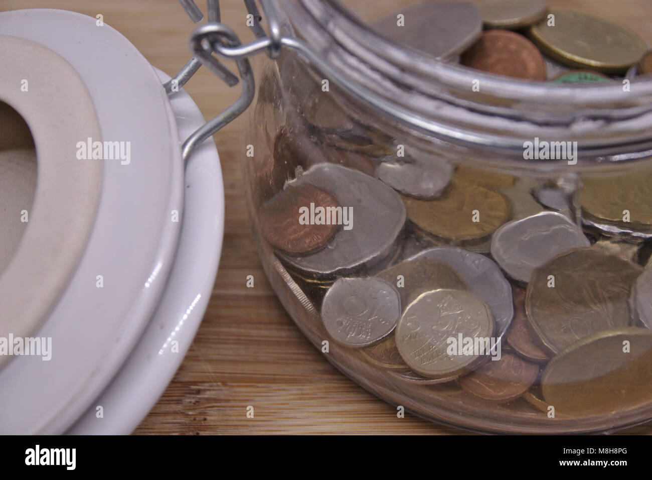 save up coins in glass Stock Photo - Alamy