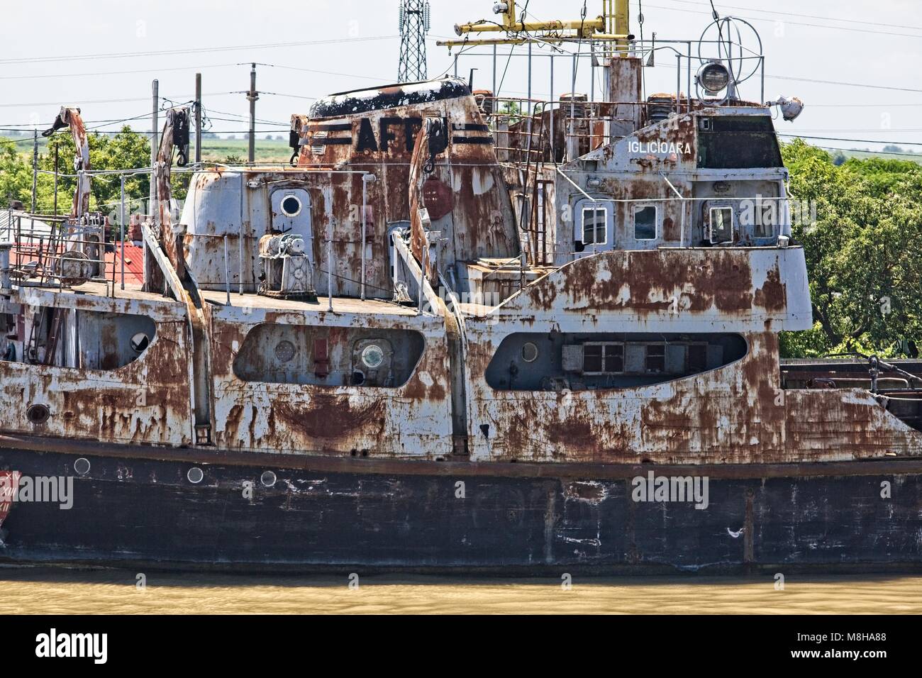 ABANDONED AND RUSTING OLD SHIP MOORED ON THE BANKS OF THE RIVER DANUBE AT SULINA ROMANIA Stock Photo