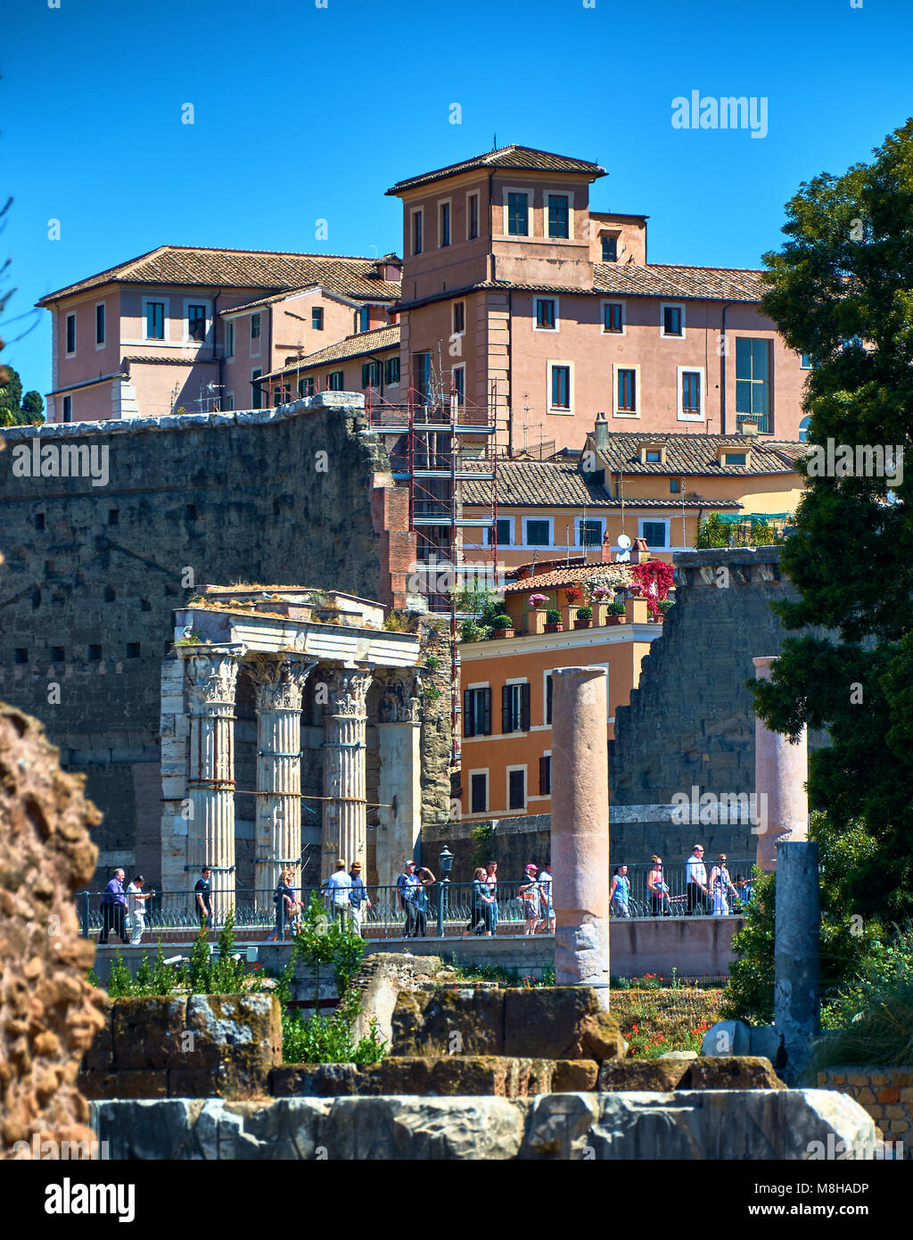 Ruins at the Roman Forum. It is a rectangular forum surrounded by the ruins of several important ancient government buildings of the city. Stock Photo