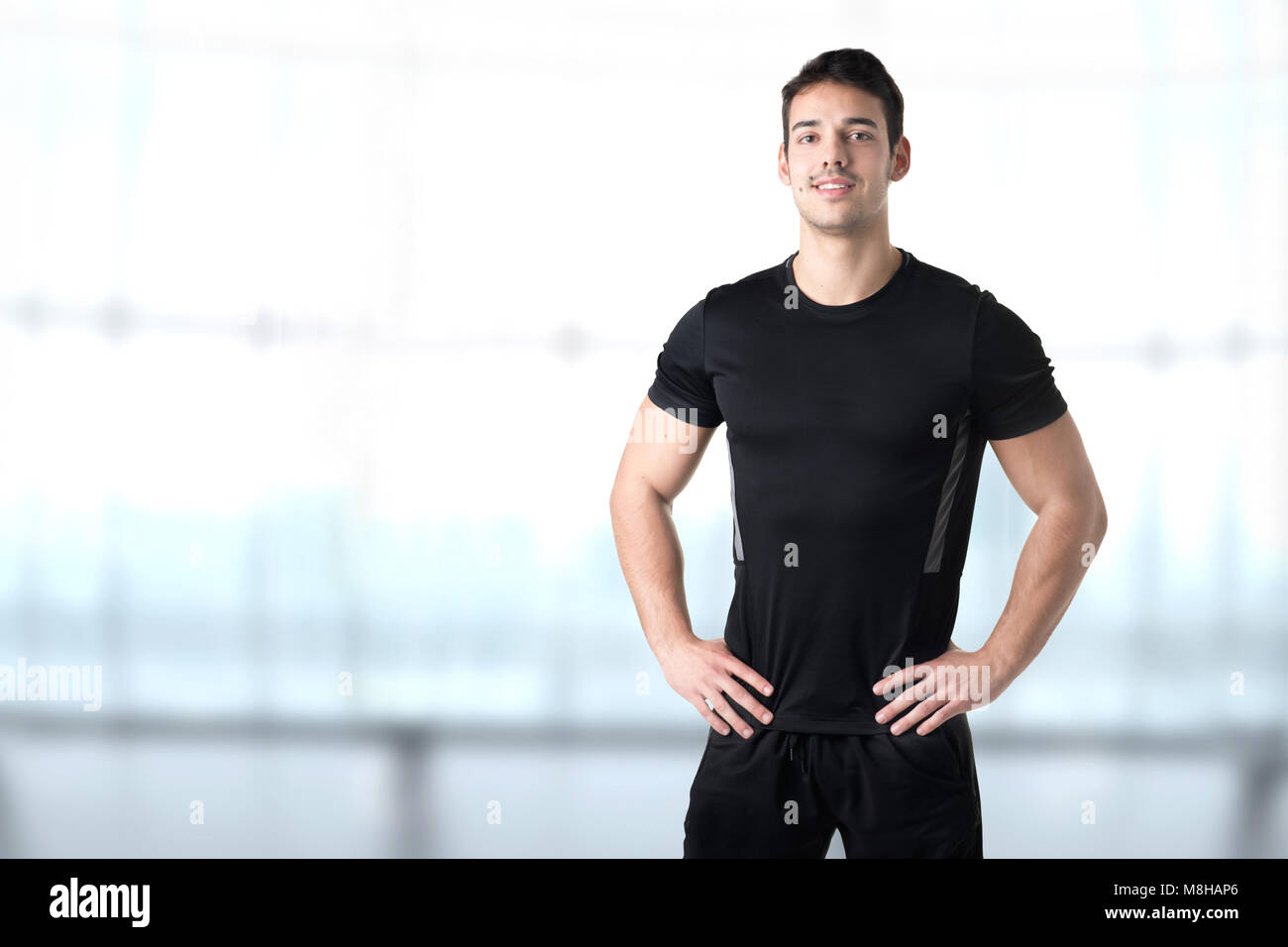 Personal Trainer With Hands on Waist in a Gym Stock Photo