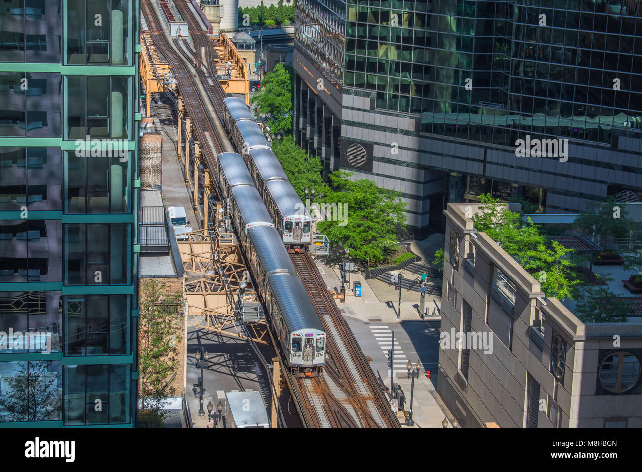 Two trains passing by in the city of Chicago - Off the beaten track. Metra Trains taking passengers in and out of the city. Commuter train in the city Stock Photo