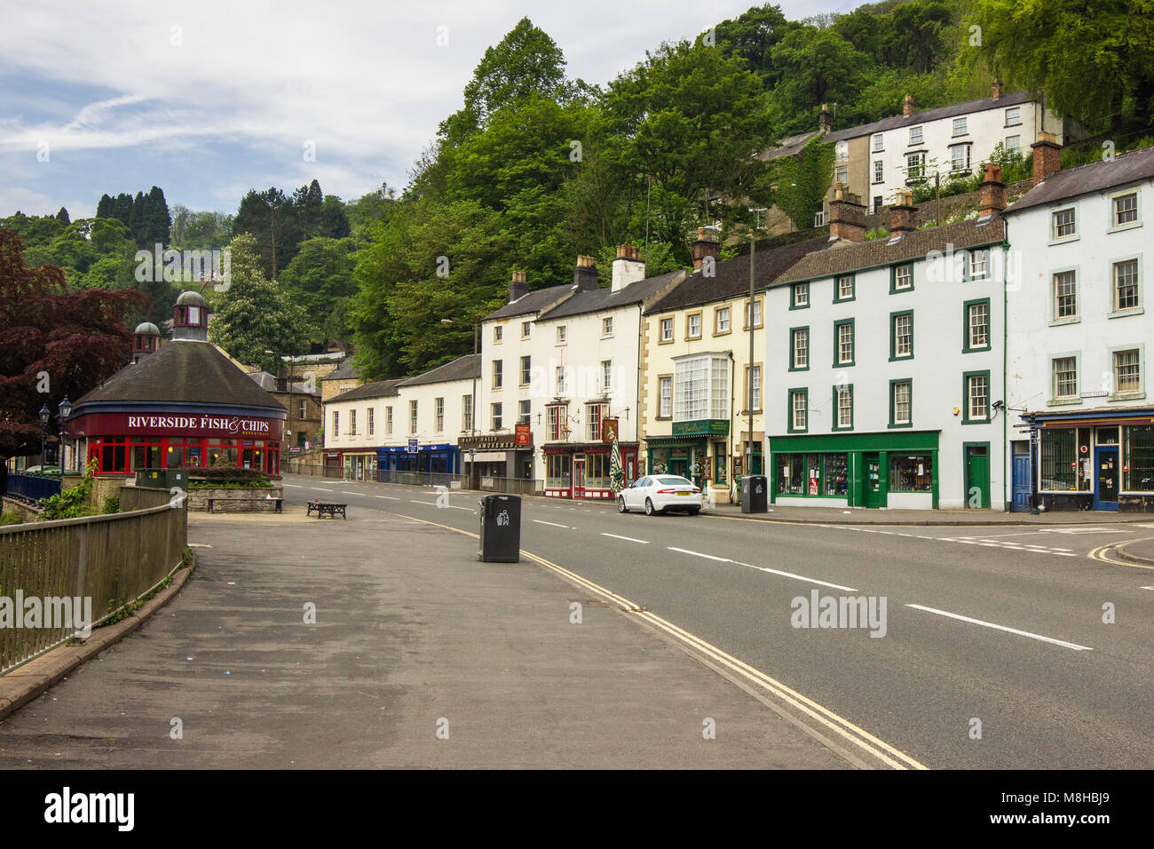 Street view of Matlock bath including shop fronts and riverside café