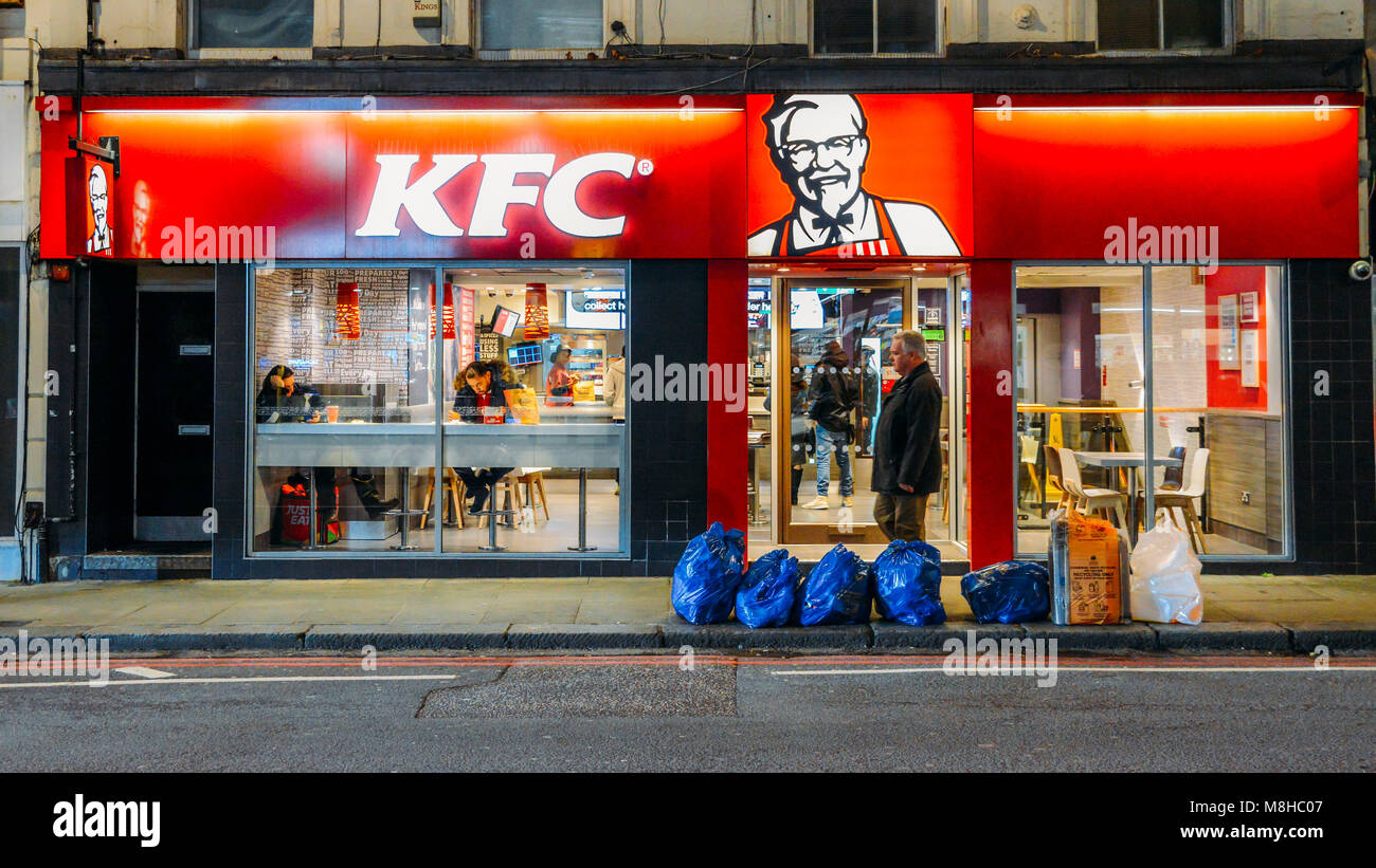Exterior of a Kentucky Fried Chicken - KFC restaurant at night on Earl's Court Road, London, England, UK Stock Photo