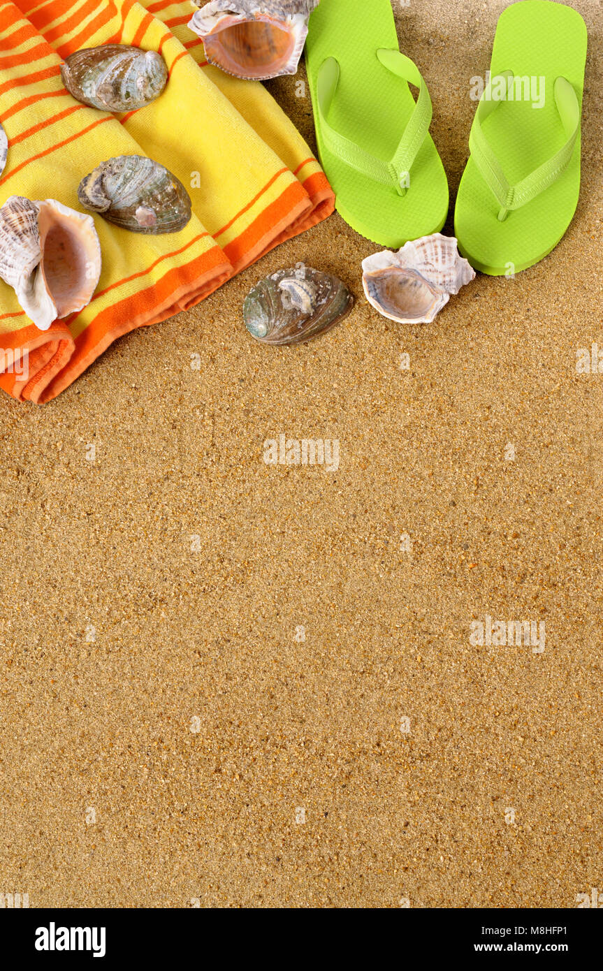 Beach background with towel and flip flops Stock Photo - Alamy