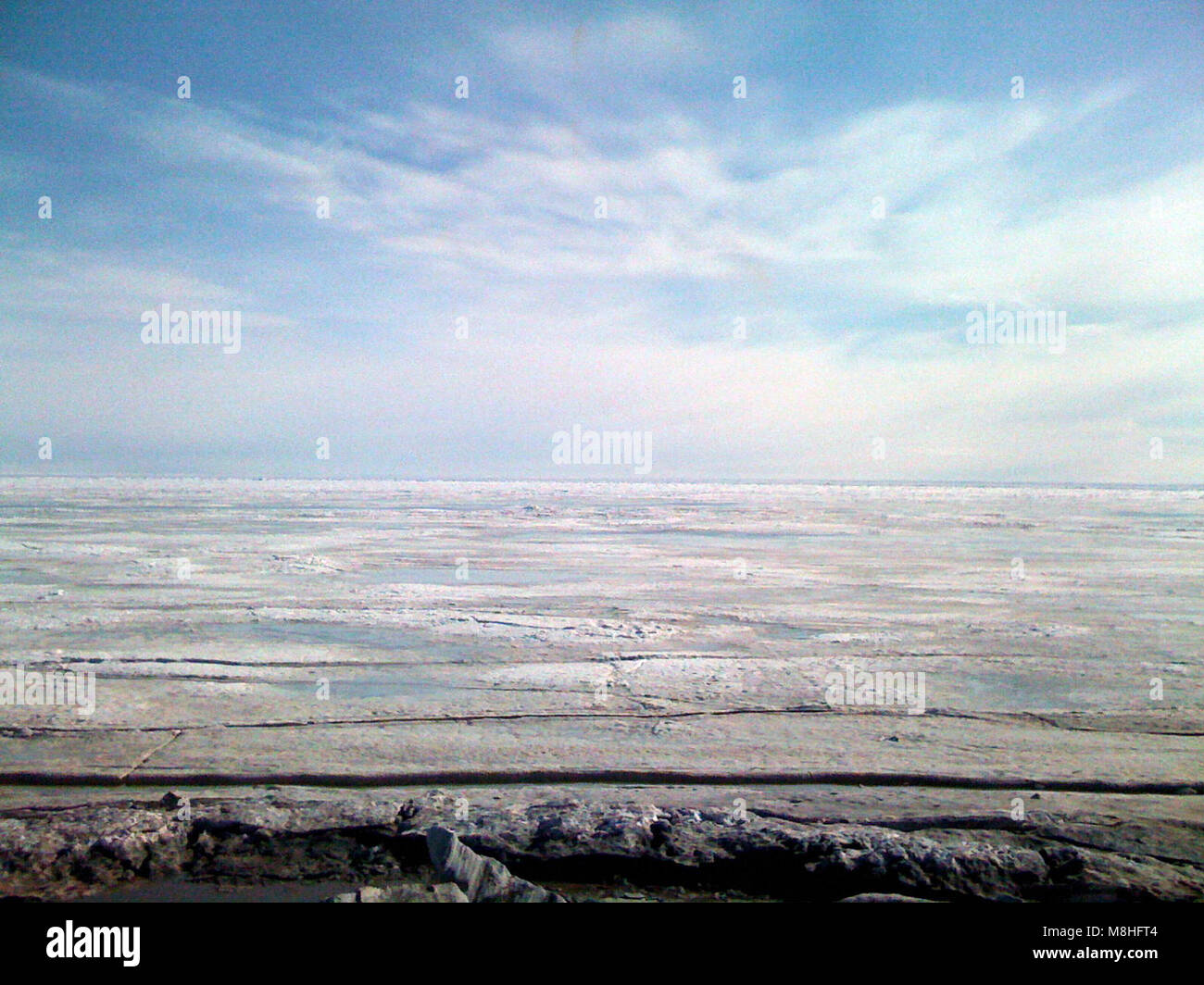 Spring Sea Ice. As the days get much, much longer the days get warmer too and the sea ice begins to melt. The shorefast ice near Bering Land Bridge Headquarters is still reaching about a half mile out. Stock Photo